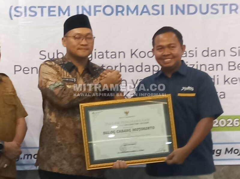 Kepala Kantor Cabang Perum Bulog Mojokerto, Muhammad Husin saat mendapat penghargaan dari Pemkab Mojokerto. (MITRAMEDIA) 