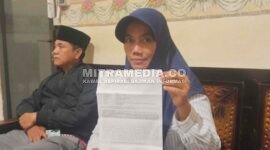 Korban saat menunjukkan bukti laporan polisi. (MITRAMEDIA) 